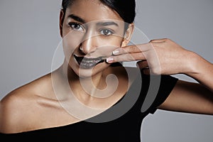 Beauty mixed race woman with a lip scrub treatment on