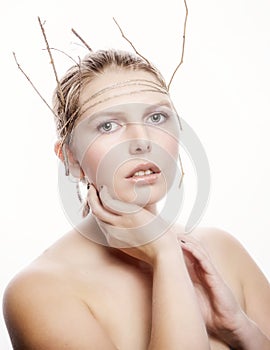 Beauty model with basic makeup and headband of twine and sticks