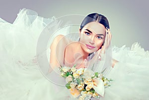 Beauty model bride in wedding dress with long train