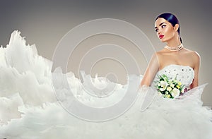 Beauty model bride in wedding dress with long train photo