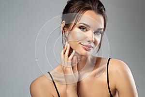 Beauty Model Face Makeup. Beautiful smiling Woman smooth Skin Make up over Gray. Facelift and Facial Treatment Care. Elegant Lady