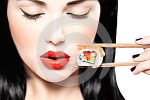 Beauty model girl eating sushi roll