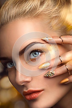 Beauty model girl with golden makeup