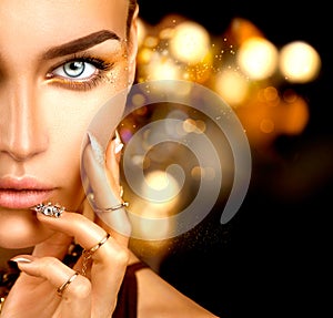 Beauty model girl with golden makeup