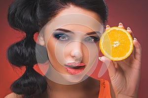 Beauty model girl with juicy oranges.
