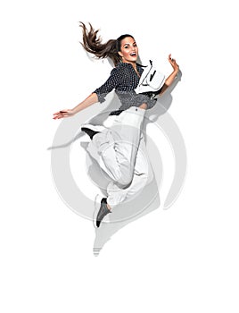 Beauty model girl jumping in trendy fashionable spring clothes, wear, apparel.  Beautiful young brunette woman in trendy outfit