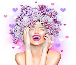 Beauty model girl with lilac flowers hairstyle