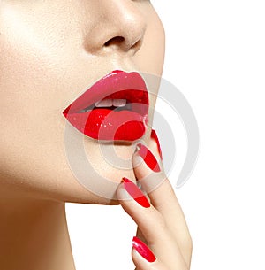 Beauty model girl with red lips and nails closeup