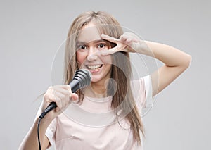 Beauty model girl singer with a microphone