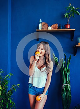 Beauty model girl takes juicy oranges