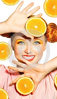 Beauty model girl takes juicy oranges
