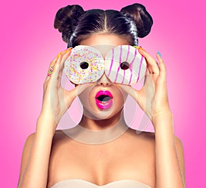 Beauty model girl taking colorful donuts