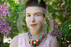 Beauty model girl wearing beads under lilac