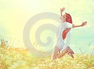 Beauty model girl in white dress jumping