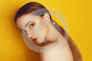 Beauty Model Girl with yellow / orange professional makeup. Orange eye shadow and lipstick  Fashion woman with long, straight hair