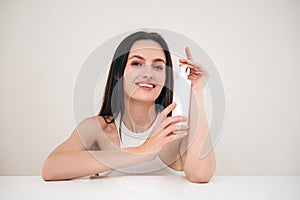 beauty model showing cosmetics product on camera