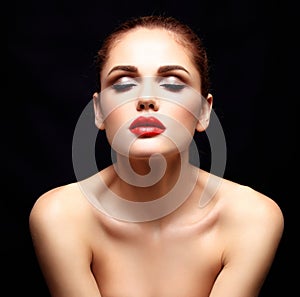 Beauty Model Woman with Long Brown Wavy Hair. Healthy Hair and Beautiful Professional Makeup. Red Lips and Smoky Eyes