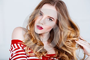 Beauty Model Woman with Long Wavy Hair. Healthy Hair and Beautiful Professional Makeup with Red Lips. Gorgeous Glamour