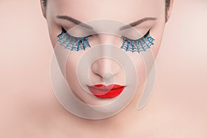 Beauty model woman with red lips and blue false eyelashes