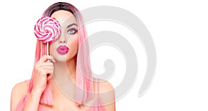 Beauty model woman with trendy pink hairstyle and beautiful makeup holding lollipop candy isolated on white