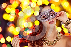 Beauty model woman wearing venetian masquerade carnival mask at party