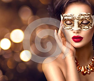 Beauty model woman wearing venetian masquerade carnival mask at party