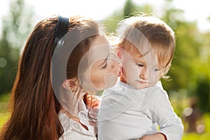 Beauty Mom and baby outdoors. Happy family playing in nature. Mo