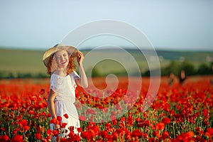 Beauty mother with teen enjoy summer days .Cute fancy dressed girl in poppy field. Field of blooming poppies.
