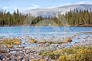 Beauty mountain summer landscape with lake from water from melted snow. Khibinsky or Khibiny tundras is on the Kola Peninsula,