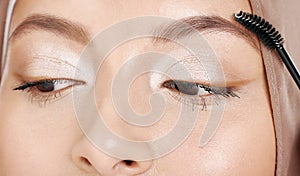 Beauty, muslim and makeup with eyebrow cosmetic tool for conservative glamour, style or elegance. Elegant eyeshadow look