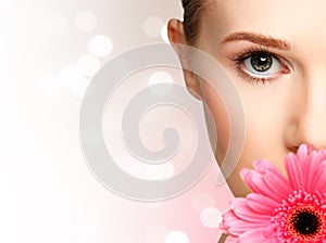 Beauty natural young girl with flower pink gerbera