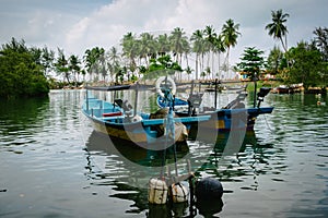 Traditional fisherman boat at Terengganu, Malaysia beach under bright sunny day and blue sky photo