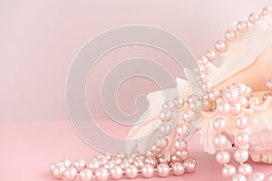 Beauty pearl beads at shell on pastel pink background