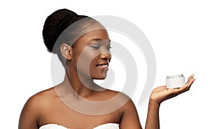 Smiling african american woman with moisturizer photo