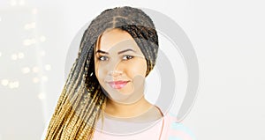 Beauty portrait of african american woman with afro hairstyle and glamour makeup on bokeh background