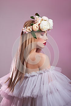 Beauty portrait art woman long hair light transparent puffy dress, bright beauty red makeup. Wreath of rose flowers on girl head.