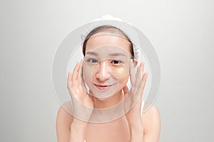 Beauty portrait of Asian attractive young woman isolated over white background, wearing towel on her head