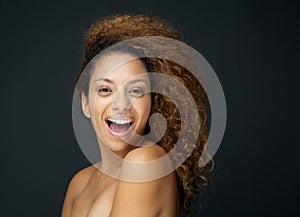 Beauty portrait of an attractive woman laughing with curly hair