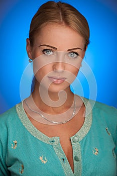 Beauty portrait of attractive young woman with blue aura in back