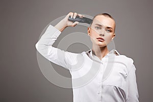 Beauty portrait of bald Girl with hairclipper