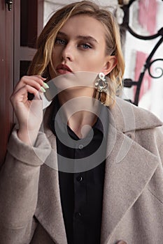 Beauty portrait of a beautiful blue eyed blonde straightening her hair