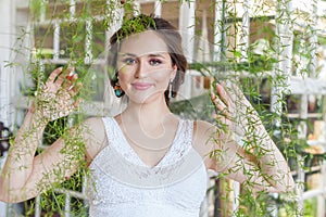 Beauty portrait of beautiful happy woman brunette smiling on green leaves background