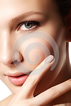 Beauty Portrait. Beautiful spa woman touching her face. Perfect