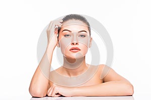 Beauty Portrait. Beautiful Spa Woman Touching her Face. Perfect Fresh Skin. Isolated on White Background. Pure Beauty