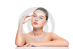 Beauty Portrait. Beautiful Spa Woman Touching her Face. Perfect Fresh Skin. Isolated on White Background. Pure Beauty