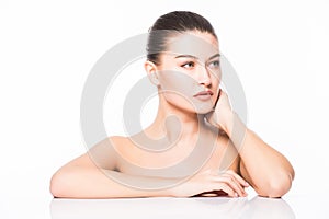 Beauty Portrait. Beautiful Spa Woman Touching her Face. Perfect Fresh Skin. Isolated on White Background. Pure Beauty