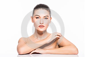 Beauty Portrait. Beautiful Spa Woman Touching her Face. Perfect Fresh Skin. Isolated on White Background. Pure Beauty