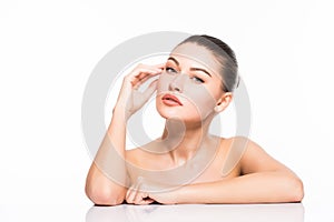 Beauty Portrait. Beautiful Spa Woman Touching her Face. Perfect Fresh Skin. Isolated on White Background. Pure Beauty