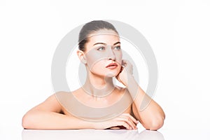 Beauty Portrait. Beautiful Spa Woman Touching her Face. Perfect Fresh Skin. Isolated on White Background. Pure Beauty