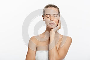 Beauty Portrait. Beautiful Spa Woman Touching her Face. Perfect Fresh Skin. Pure Beauty Model Girl. Youth and Skin Care